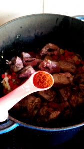 Smoked paprika being added to Spanish-inspired stew. Smoked paprika being added to Spanish-inspired stew.