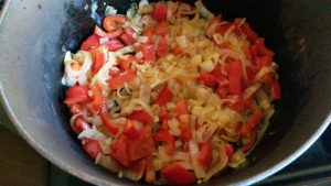 Onion, pepper and garlic sweating off in a casserole pan. Onion, pepper and garlic sweating off in a casserole pan.